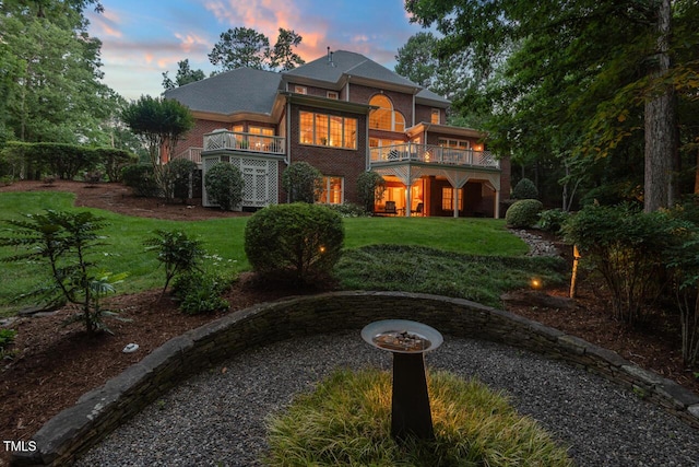 3606 Dairy Pond Pl, Durham, NC 27705 - back of house at dusk with a lawn and a balcony