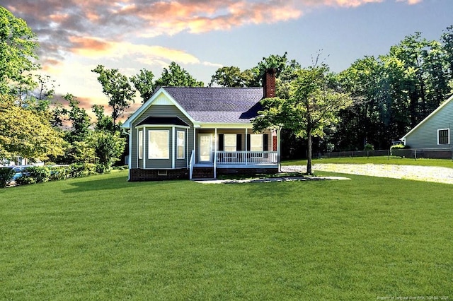 4101 Carson Dr, Sanford, NC 27332 - back of house at dusk featuring a porch, a chimney, crawl space, and a shingled roof