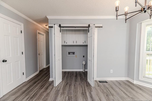 4101 Carson Dr, Sanford, NC 27332 - laundry area featuring cabinet space, hookup for a washing machine, hookup for an electric dryer, a barn door, and wood finished floors