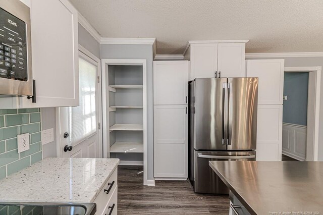 4101 Carson Dr, Sanford, NC 27332 - kitchen featuring stainless steel appliances, dark wood-type flooring, ornamental molding, white cabinetry, and light stone countertops