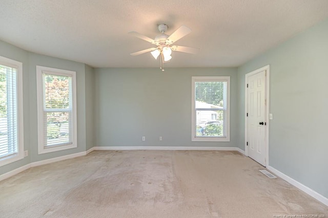 4101 Carson Dr, Sanford, NC 27332 - empty room featuring healthy amount of natural light, light colored carpet, a textured ceiling, and ceiling fan