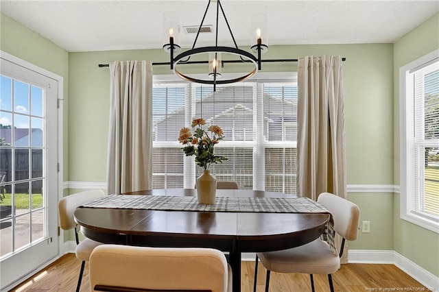 167 Westminster Dr, Raeford, NC 28376 - dining room featuring a chandelier, light wood finished floors, and plenty of natural light