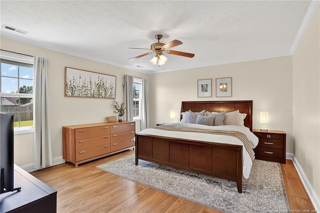 167 Westminster Dr, Raeford, NC 28376 - bedroom with light wood-style floors, ornamental molding, ceiling fan, and a textured ceiling