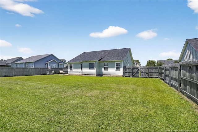 167 Westminster Dr, Raeford, NC 28376 - rear view of property with a fenced backyard and a shingled roof
