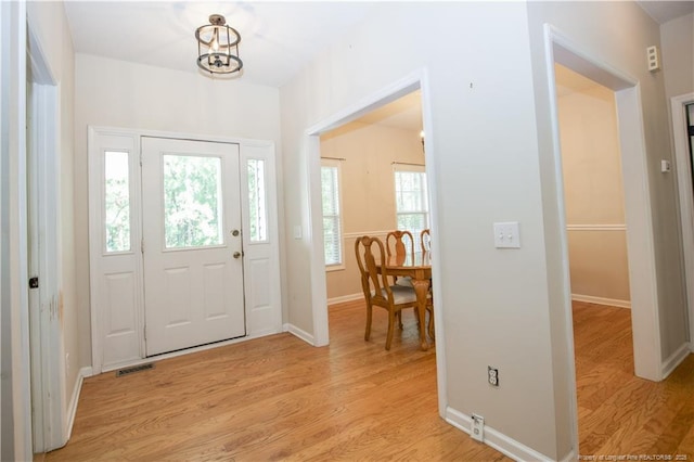 130 Pinecone Ct, Seven Lakes, NC 27376 - foyer featuring light wood-type flooring and a chandelier