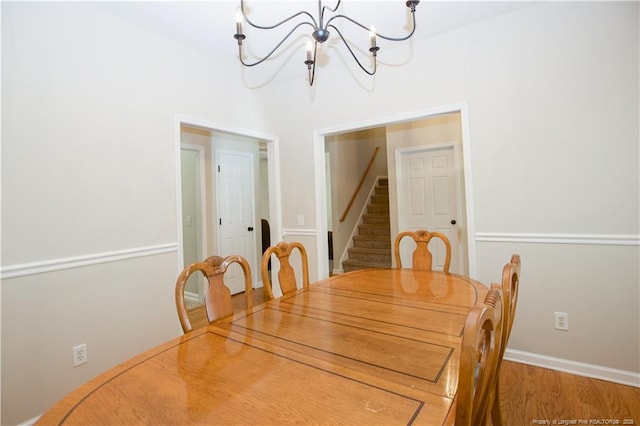 130 Pinecone Ct, Seven Lakes, NC 27376 - dining space featuring a chandelier, stairs, and wood finished floors