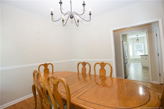 130 Pinecone Ct, Seven Lakes, NC 27376 - dining area featuring a chandelier and baseboards