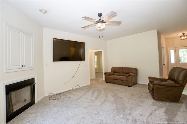 130 Pinecone Ct, Seven Lakes, NC 27376 - carpeted living room featuring ceiling fan, a fireplace, and a chandelier