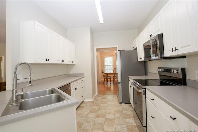 130 Pinecone Ct, Seven Lakes, NC 27376 - kitchen with stainless steel appliances, white cabinetry, and light countertops