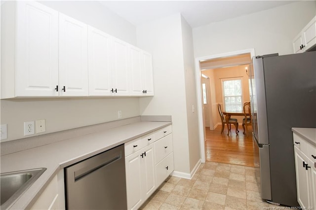 130 Pinecone Ct, Seven Lakes, NC 27376 - kitchen featuring stainless steel appliances, white cabinets, and light countertops