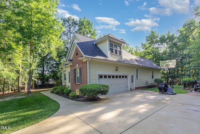 15 Cole Creek Way, Franklinton, NC 27525 - view of home's exterior with concrete driveway, a yard, roof with shingles, brick siding, and a garage