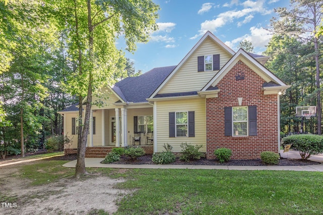 15 Cole Creek Way, Franklinton, NC 27525 - view of front of home featuring covered porch, a front lawn, roof with shingles, and brick siding