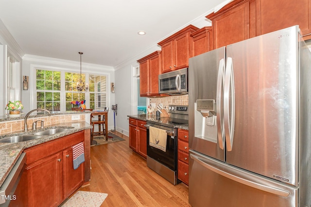15 Cole Creek Way, Franklinton, NC 27525 - kitchen with stainless steel appliances, decorative backsplash, crown molding, light wood-style flooring, and a chandelier