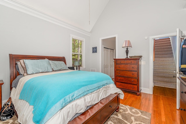 15 Cole Creek Way, Franklinton, NC 27525 - bedroom featuring wood finished floors, high vaulted ceiling, and a closet
