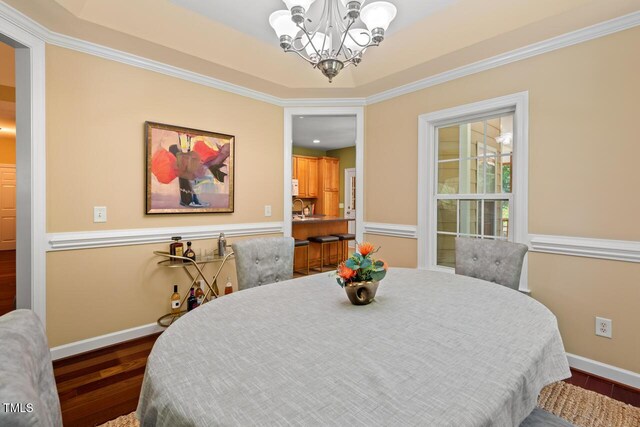 126 Captains Ct, Durham, NC 27712 - dining area featuring a chandelier, wood finished floors, and ornamental molding