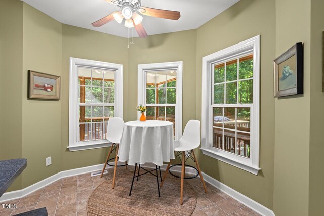 126 Captains Ct, Durham, NC 27712 - dining room featuring a ceiling fan and stone finish flooring