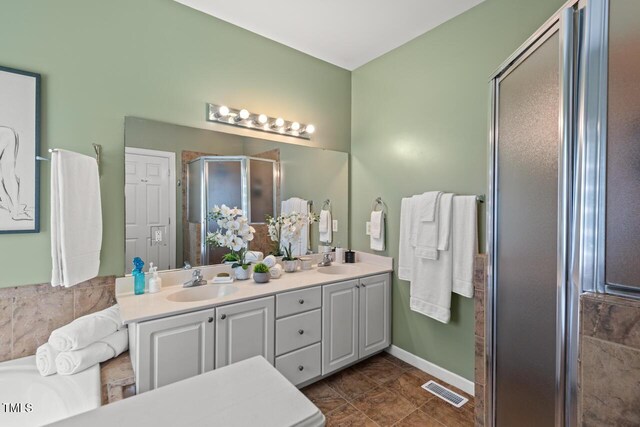 126 Captains Ct, Durham, NC 27712 - bathroom with a stall shower and double vanity
