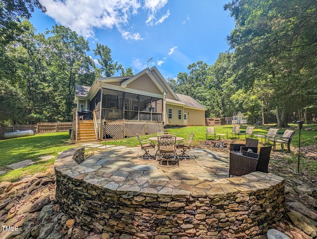 126 Captains Ct, Durham, NC 27712 - fenced backyard with a sunroom, a fire pit, a patio area, and stairway