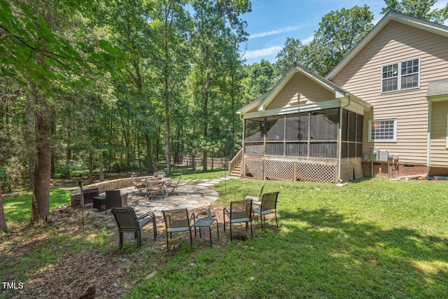 126 Captains Ct, Durham, NC 27712 - view of green lawn featuring a sunroom, a patio area, and an outdoor fire pit