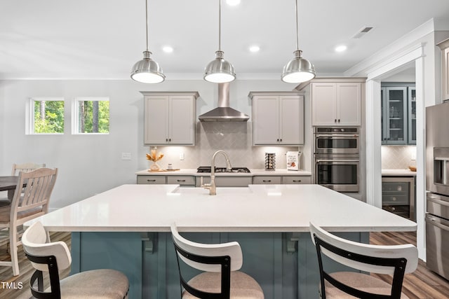 8341 Running Fern Way, Willow Springs, NC 27592 - kitchen featuring appliances with stainless steel finishes, wall chimney range hood, backsplash, wine cooler, and light countertops