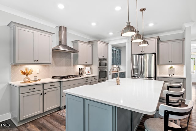 8341 Running Fern Way, Willow Springs, NC 27592 - kitchen with stainless steel appliances, wall chimney range hood, gray cabinets, crown molding, and a kitchen bar