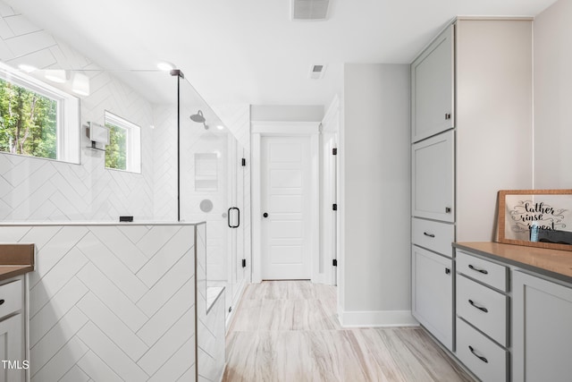 8341 Running Fern Way, Willow Springs, NC 27592 - bathroom with a stall shower, vanity, and marble look tiles