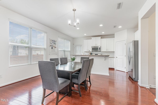 543 Callandale Ln, Durham, NC 27703 - dining area with a chandelier, dark wood-style floors, and recessed lighting