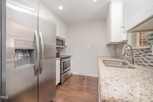 200 Old Spring Hill Ln, Fuquay Varina, NC 27526 - kitchen featuring appliances with stainless steel finishes, tasteful backsplash, dark wood-style floors, white cabinetry, and recessed lighting