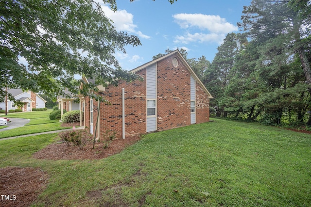 200 Old Spring Hill Ln, Fuquay Varina, NC 27526 - view of side of home featuring a lawn and brick siding