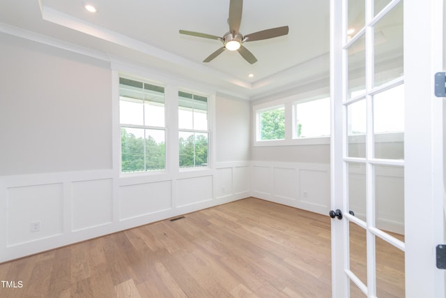 0 Bluestone Ct Lot 22R, Chapel Hill, NC 27514 - empty room with a decorative wall, a tray ceiling, ceiling fan, a wainscoted wall, and light wood-type flooring