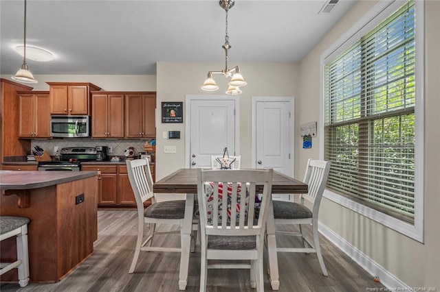 50 Turner Mathews Ct, Spring Lake, NC 28390 - kitchen with stainless steel appliances, tasteful backsplash, brown cabinetry, and wood finished floors