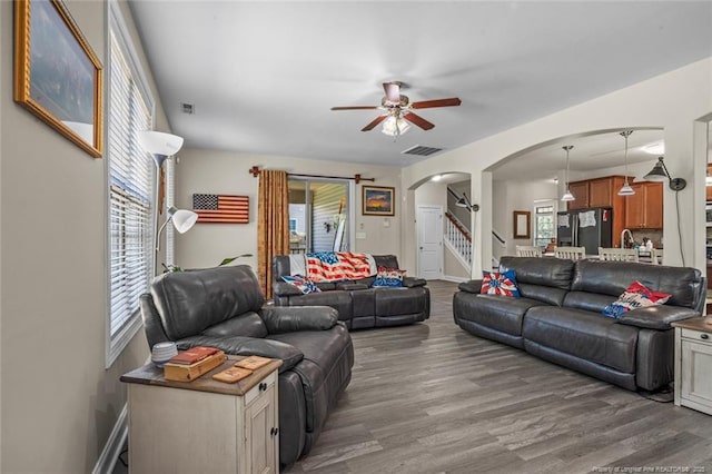 50 Turner Mathews Ct, Spring Lake, NC 28390 - living room with arched walkways, a ceiling fan, healthy amount of natural light, and wood finished floors