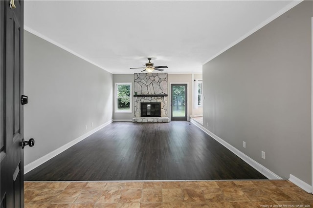 2012 Cobblestone Pl, Fayetteville, NC 28304 - unfurnished living room with a stone fireplace, a ceiling fan, ornamental molding, and wood finished floors