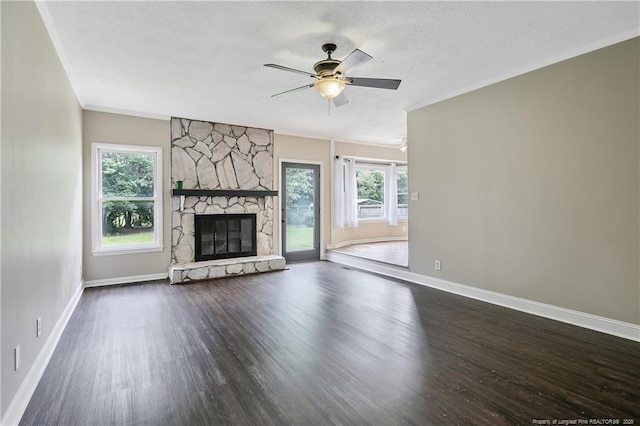 2012 Cobblestone Pl, Fayetteville, NC 28304 - unfurnished living room featuring wood finished floors, a ceiling fan, a fireplace, a textured ceiling, and ornamental molding