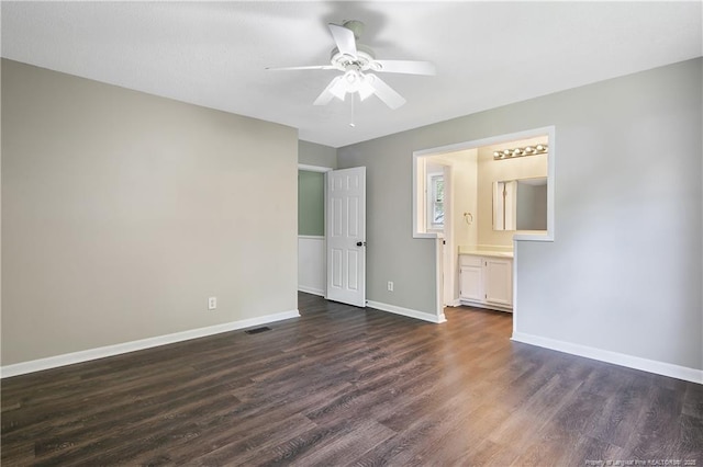 2012 Cobblestone Pl, Fayetteville, NC 28304 - unfurnished bedroom featuring dark wood-style floors, connected bathroom, and a ceiling fan