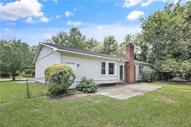 2012 Cobblestone Pl, Fayetteville, NC 28304 - rear view of house with a patio area, a chimney, and a shingled roof