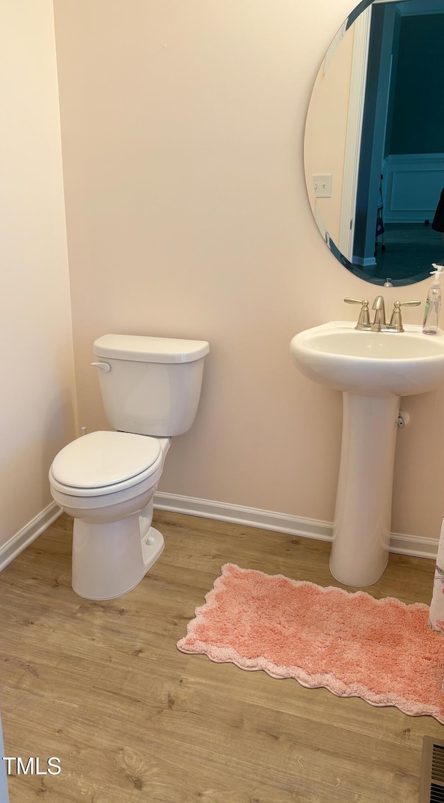 644 Wall Rd, Wendell, NC 27591 - half bathroom with baseboards and wood finished floors