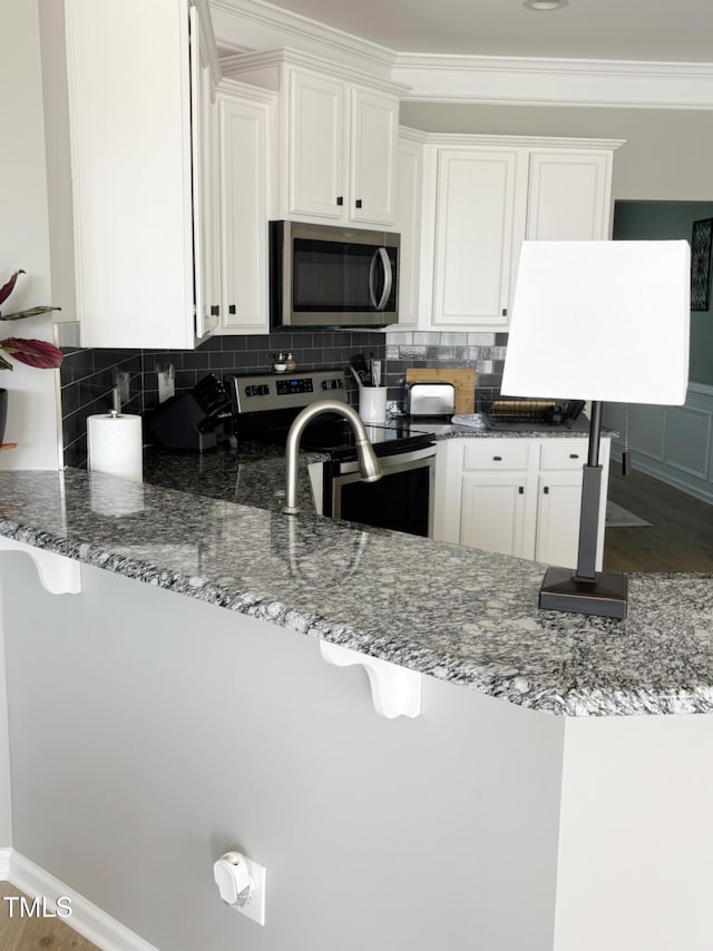 644 Wall Rd, Wendell, NC 27591 - kitchen featuring stainless steel appliances, dark stone counters, white cabinets, backsplash, and crown molding