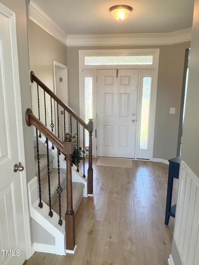 644 Wall Rd, Wendell, NC 27591 - foyer entrance featuring wood finished floors, crown molding, and stairs
