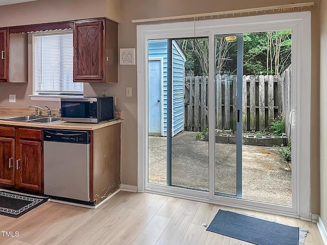 5810 Shady Grove Cir, Raleigh, NC 27609 - kitchen with stainless steel appliances, light wood-style flooring, light countertops, and plenty of natural light