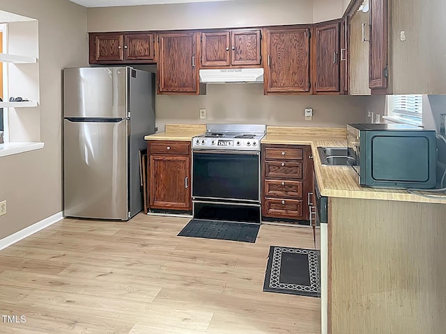 5810 Shady Grove Cir, Raleigh, NC 27609 - kitchen featuring freestanding refrigerator, electric stove, under cabinet range hood, light countertops, and light wood-style flooring