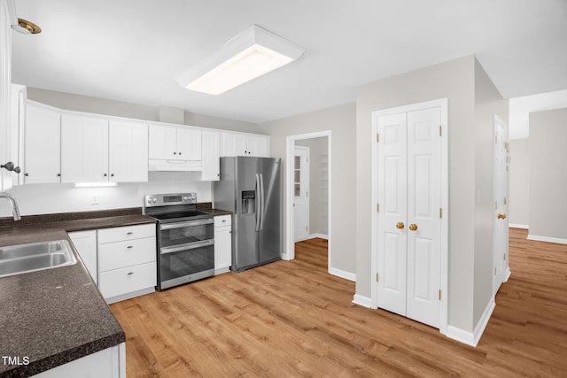514 Lipscomb Grove Church Rd, Hillsborough, NC 27278 - kitchen with appliances with stainless steel finishes, under cabinet range hood, light wood-style floors, dark countertops, and white cabinetry