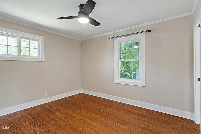 2609 Elmhurst Cir, Raleigh, NC 27610 - empty room featuring plenty of natural light, wood finished floors, crown molding, and a ceiling fan