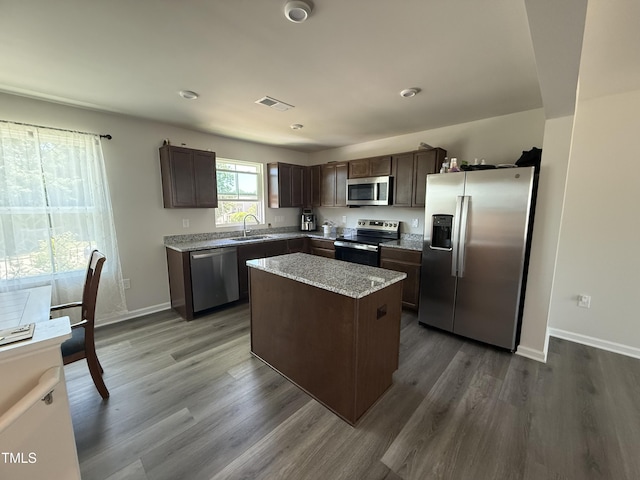 4500 Black Drum Dr, Raleigh, NC 27616 - kitchen with stainless steel appliances, dark brown cabinetry, dark wood-type flooring, and a kitchen island
