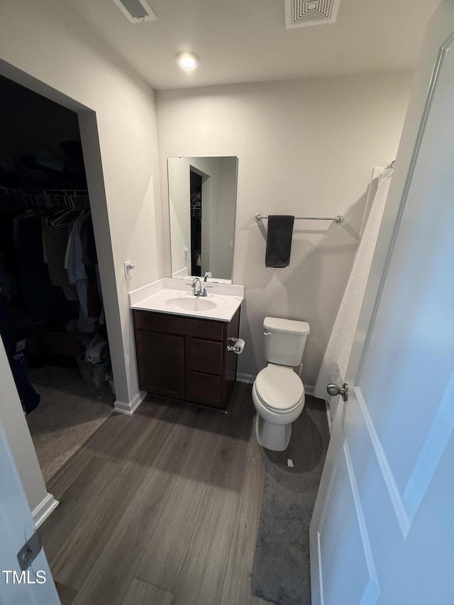 4500 Black Drum Dr, Raleigh, NC 27616 - full bathroom with wood finished floors, vanity, and a walk in closet