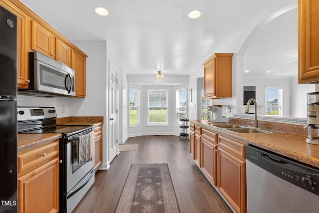 108 Hudson Dr, Princeton, NC 27569 - kitchen featuring stainless steel appliances, healthy amount of natural light, dark wood-style floors, recessed lighting, and arched walkways