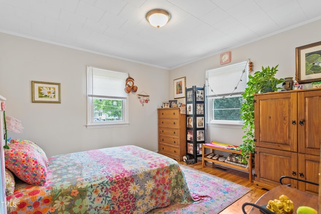 302 Bradley St, Burlington, NC 27215 - bedroom with multiple windows, light wood finished floors, and crown molding