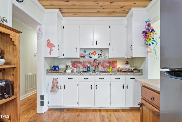 302 Bradley St, Burlington, NC 27215 - kitchen featuring freestanding refrigerator, open shelves, white cabinets, wood ceiling, and decorative backsplash