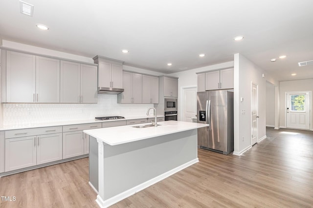 1113 Umstead Grove Way, Durham, NC 27712 - kitchen with appliances with stainless steel finishes, gray cabinetry, under cabinet range hood, light wood-style floors, and recessed lighting