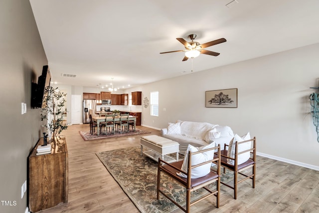 4102 Catfish Way, Durham, NC 27703 - living area with a chandelier, a ceiling fan, and light wood finished floors